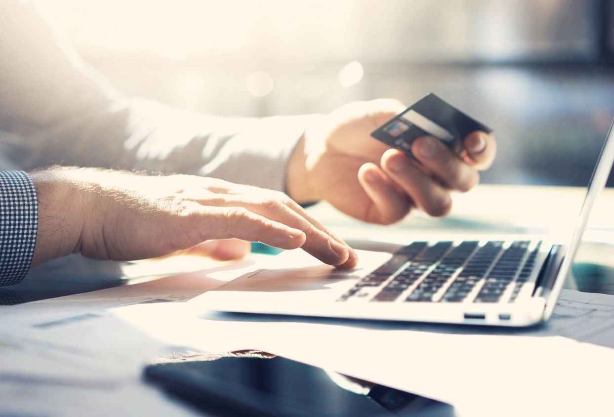 Business customer making an online card payment on a laptop